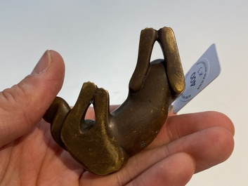 Two Chinese bronze scroll weights and a seal stamp, Qing