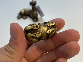 Two Chinese bronze scroll weights and a seal stamp, Qing