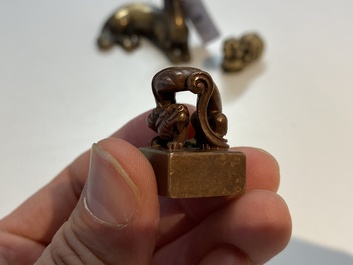 Two Chinese bronze scroll weights and a seal stamp, Qing