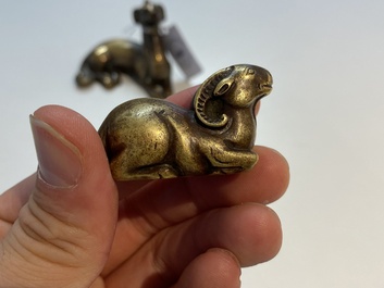 Two Chinese bronze scroll weights and a seal stamp, Qing