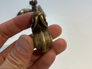 Two Chinese bronze scroll weights and a seal stamp, Qing