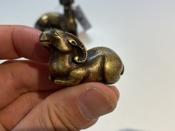 Two Chinese bronze scroll weights and a seal stamp, Qing