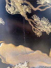 A large Japanese wooden screen with a central gilt-lacquered and ivory-inlaid panel, Meiji
