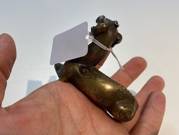 Two Chinese bronze scroll weights and a seal stamp, Qing