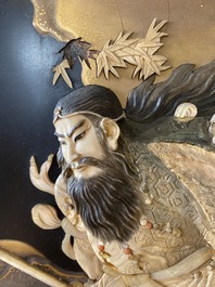 A large Japanese wooden screen with a central gilt-lacquered and ivory-inlaid panel, Meiji