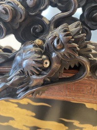 A large Japanese wooden screen with a central gilt-lacquered and ivory-inlaid panel, Meiji