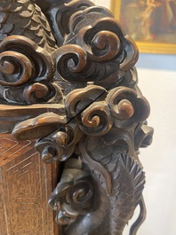A large Japanese wooden screen with a central gilt-lacquered and ivory-inlaid panel, Meiji