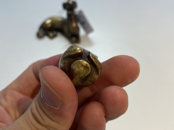 Two Chinese bronze scroll weights and a seal stamp, Qing