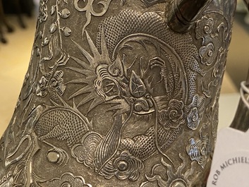 A Chinese silver teapot with birds among blossoming branches, 19th C.
