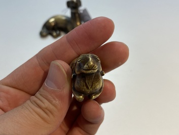 Two Chinese bronze scroll weights and a seal stamp, Qing
