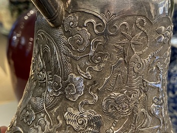 A Chinese silver teapot with birds among blossoming branches, 19th C.