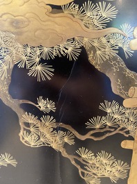 A large Japanese wooden screen with a central gilt-lacquered and ivory-inlaid panel, Meiji