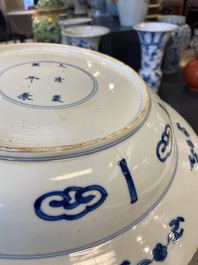 A Chinese blue and white dish with two ladies and two rabbits in a garden, Kangxi mark and of the period