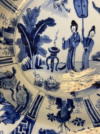 A Chinese blue and white dish with two ladies and two rabbits in a garden, Kangxi mark and of the period