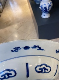 A Chinese blue and white dish with two ladies and two rabbits in a garden, Kangxi mark and of the period
