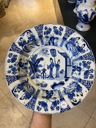 A Chinese blue and white dish with two ladies and two rabbits in a garden, Kangxi mark and of the period