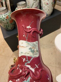 A pair of Chinese famille rose ruby-ground vases, 19th C.