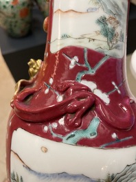 A pair of Chinese famille rose ruby-ground vases, 19th C.