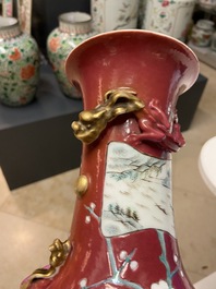 A pair of Chinese famille rose ruby-ground vases, 19th C.