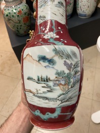 A pair of Chinese famille rose ruby-ground vases, 19th C.
