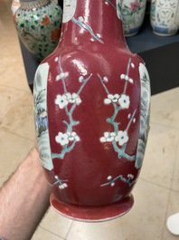 A pair of Chinese famille rose ruby-ground vases, 19th C.