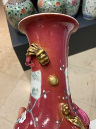 A pair of Chinese famille rose ruby-ground vases, 19th C.