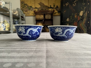 A pair of Chinese blue and white 'dragon' bowls, Kangxi mark, 19/20th C.