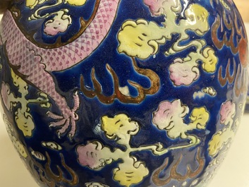 A Chinese famille verte 'mythical animals' vase and a famille rose jar and cover with dragons, 19/20th C.