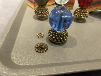 Five Chinese glass and gilt brass finials for Mandarin hats in their original boxes, 19th C.