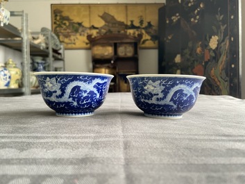 A pair of Chinese blue and white 'dragon' bowls, Kangxi mark, 19/20th C.