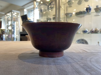 A Chinese aubergine-glazed bowl with incised design of cranes, Kangxi