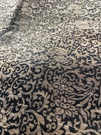 A Chinese embroidered silk woman's robe with floral scrolls, 19th C.