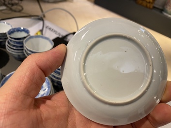 Twenty-one Chinese blue and white saucers and eighteen cups, Kangxi