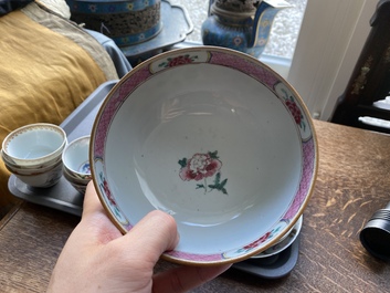 A varied collection of Chinese famille rose and grisaille cups and saucers and a 'rooster' bowl, Yongzheng/Qianlong
