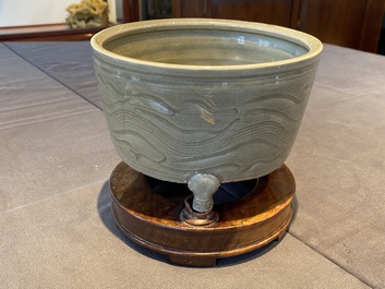 Een Chinese Longquan celadon driepotige wierookbrander met kintsugi herstelling op houten sokkel, Ming