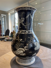 A Chinese famille noire vase with grisaille and iron-red design, 19th C.