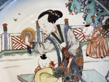 A Chinese famille verte dish with a lady and two playing boys, Kangxi