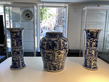 A large Chinese blue and white garniture of three vases, Kangxi