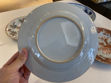 A Chinese blue and white 'dragon' dish and three iron-red and famille rose plates, 18th C.