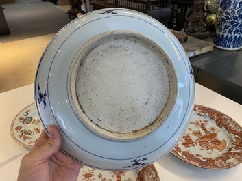 A Chinese blue and white 'dragon' dish and three iron-red and famille rose plates, 18th C.