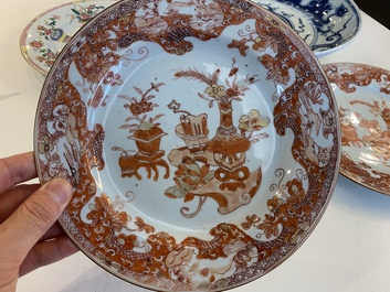 A Chinese blue and white 'dragon' dish and three iron-red and famille rose plates, 18th C.
