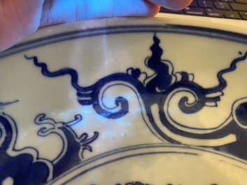 A Chinese blue and white 'dragon' dish and three iron-red and famille rose plates, 18th C.