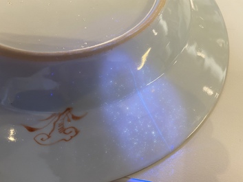 A Chinese blue and white 'dragon' dish and three iron-red and famille rose plates, 18th C.
