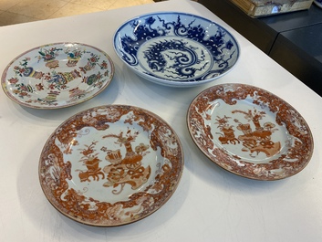A Chinese blue and white 'dragon' dish and three iron-red and famille rose plates, 18th C.