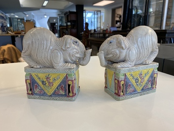 A pair of Chinese famille rose elephants on stands, 20th C.