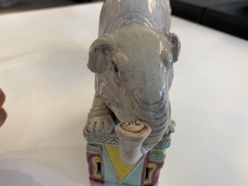 A pair of Chinese famille rose elephants on stands, 20th C.