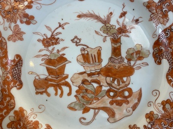A Chinese blue and white 'dragon' dish and three iron-red and famille rose plates, 18th C.
