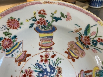 A Chinese blue and white 'dragon' dish and three iron-red and famille rose plates, 18th C.