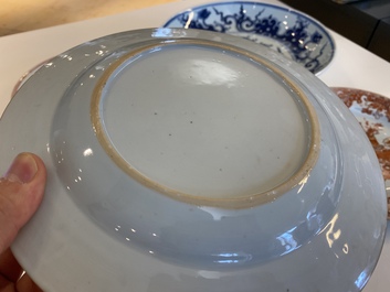 A Chinese blue and white 'dragon' dish and three iron-red and famille rose plates, 18th C.