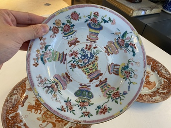 A Chinese blue and white 'dragon' dish and three iron-red and famille rose plates, 18th C.